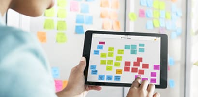 Jonge vrouw die een kanbanbord opzet om met de app op een kanbanbord te kunnen werken